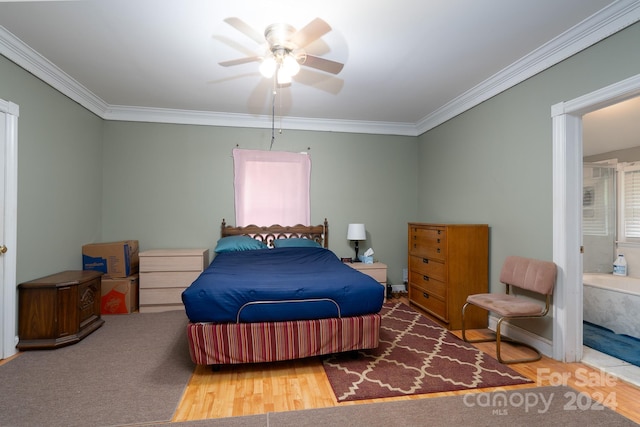 bedroom featuring ceiling fan, connected bathroom, wood-type flooring, and ornamental molding