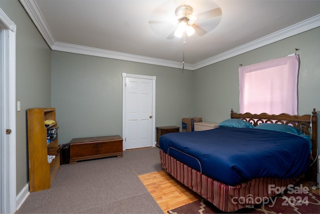 bedroom featuring ceiling fan, ornamental molding, and carpet floors