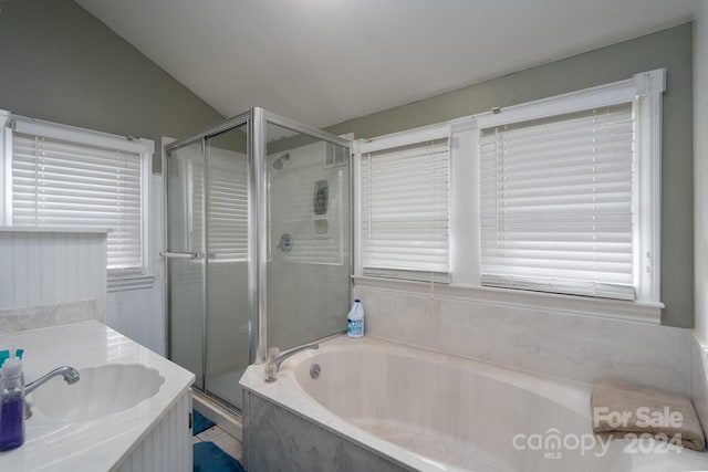 bathroom featuring vanity, lofted ceiling, and shower with separate bathtub