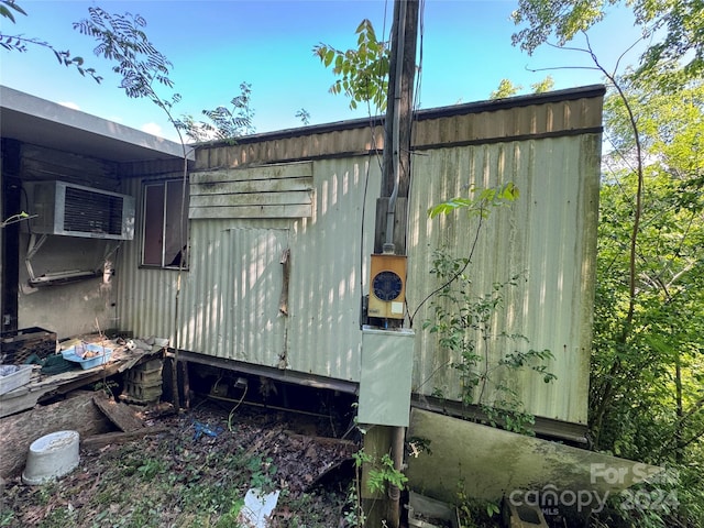 view of side of home featuring a storage unit