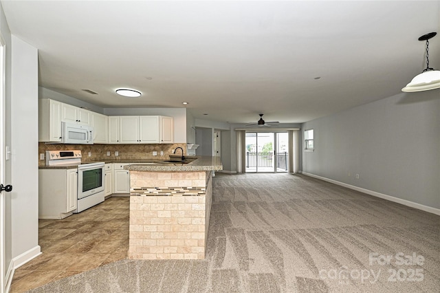 kitchen featuring ceiling fan, white cabinetry, hanging light fixtures, backsplash, and white appliances