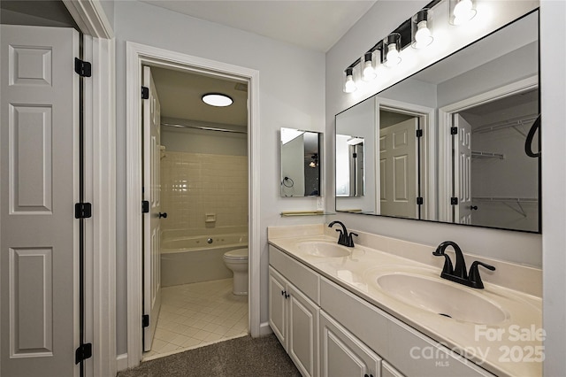 bathroom featuring tile patterned floors, vanity, and toilet