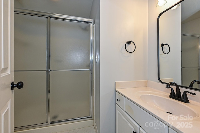 bathroom with vanity and a shower with shower door