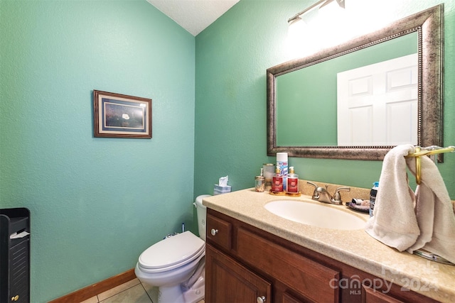 bathroom with toilet, tile floors, and vanity