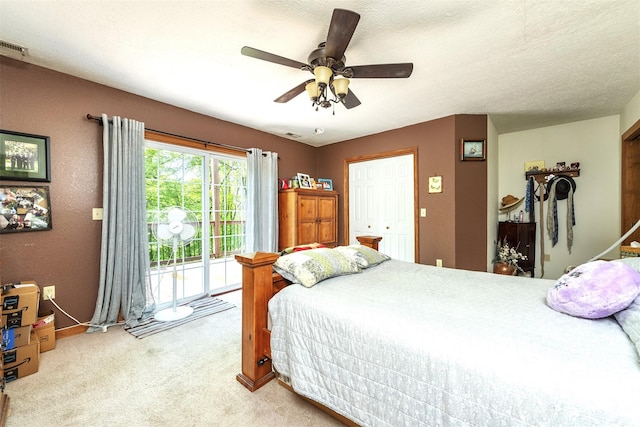 carpeted bedroom featuring a closet, a textured ceiling, ceiling fan, and access to exterior