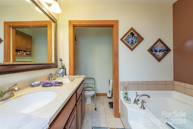 bathroom featuring vanity with extensive cabinet space, tile floors, toilet, and a bath