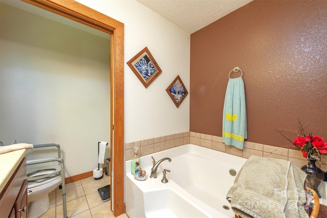 bathroom featuring vanity, a washtub, tile flooring, toilet, and a textured ceiling