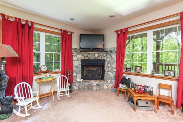 carpeted living room featuring plenty of natural light and a fireplace