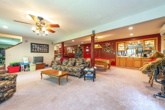 living room featuring light carpet, decorative columns, pool table, ceiling fan, and a textured ceiling