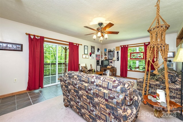 tiled living room with ceiling fan and a textured ceiling