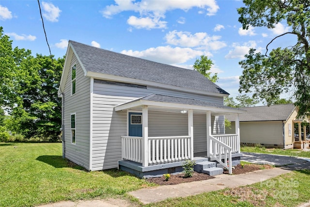 view of front facade with a front lawn and a porch