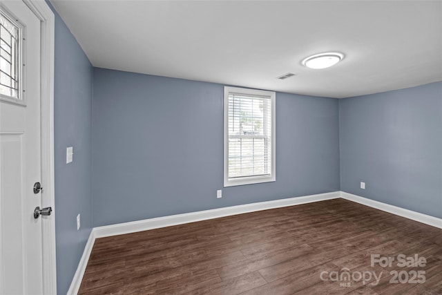 unfurnished room featuring dark hardwood / wood-style floors