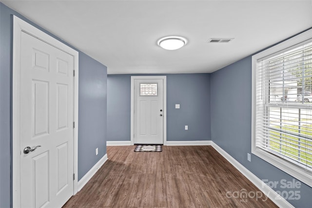 entrance foyer with plenty of natural light and dark wood-type flooring