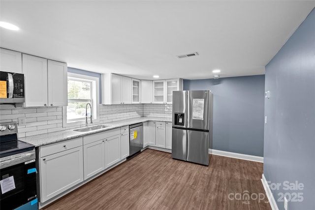 kitchen featuring white cabinetry, sink, and appliances with stainless steel finishes