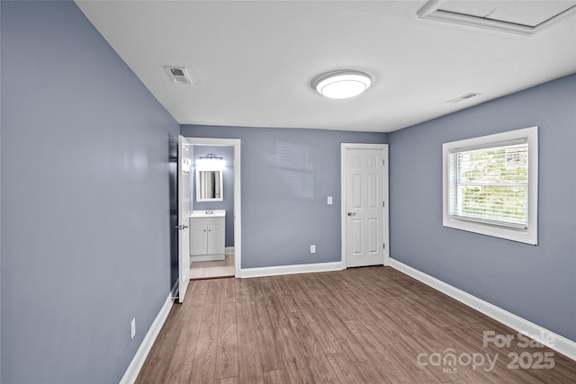 empty room with hardwood / wood-style floors