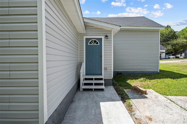 entrance to property with a yard