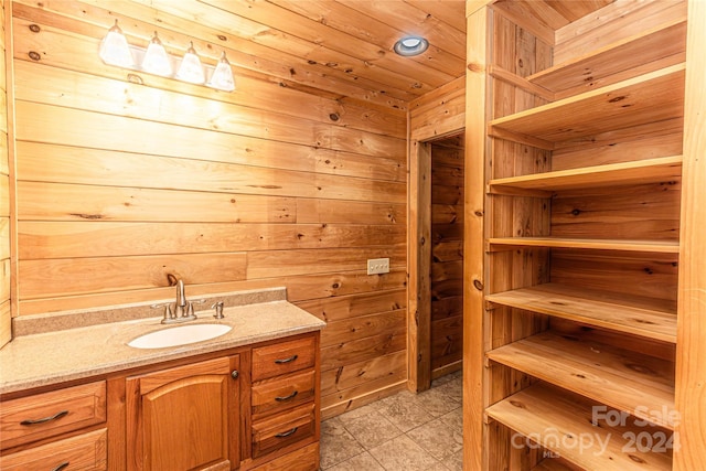 bathroom featuring wooden walls and vanity