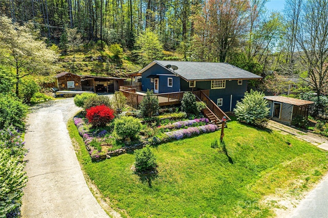 view of front of house with a front yard and an outdoor structure