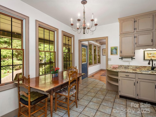 tiled dining space with an inviting chandelier and sink