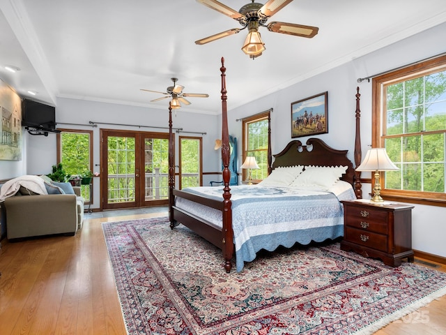 bedroom featuring ornamental molding, ceiling fan, light hardwood / wood-style floors, and french doors