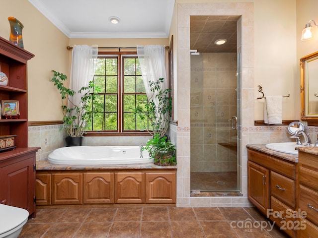 full bathroom featuring tile walls, shower with separate bathtub, crown molding, and vanity