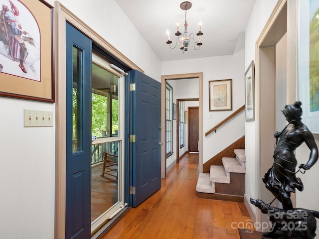 entryway featuring an inviting chandelier and hardwood / wood-style floors