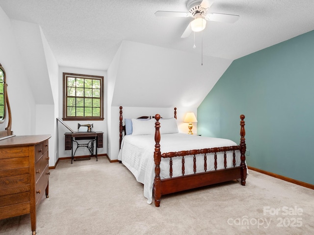 carpeted bedroom featuring a textured ceiling, ceiling fan, and vaulted ceiling