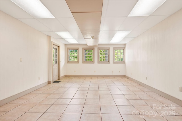 tiled spare room with a wealth of natural light