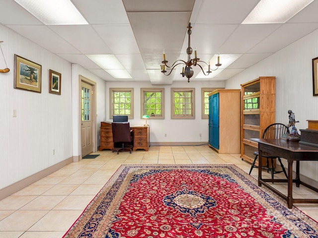 tiled home office featuring a notable chandelier and a paneled ceiling