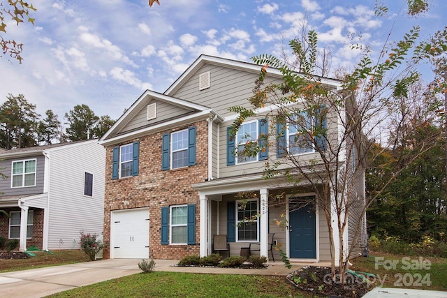 view of front of property featuring a garage and covered porch