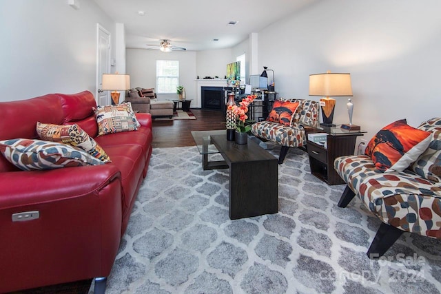 living room with hardwood / wood-style floors and ceiling fan