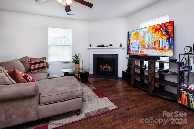 living room with ceiling fan and dark hardwood / wood-style floors