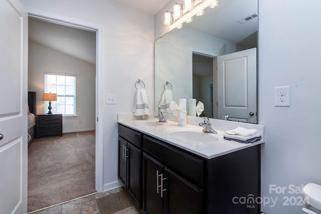 bathroom featuring vanity and vaulted ceiling