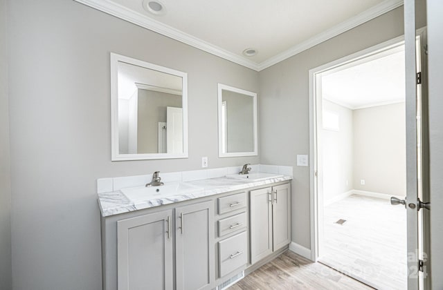 bathroom with vanity, crown molding, and hardwood / wood-style floors