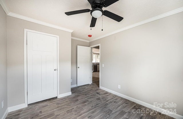 unfurnished bedroom featuring crown molding, a textured ceiling, wood-type flooring, and ceiling fan