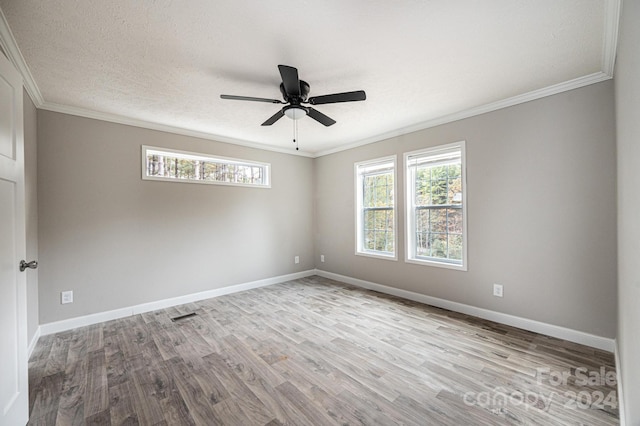 spare room with ceiling fan, a healthy amount of sunlight, and light wood-type flooring