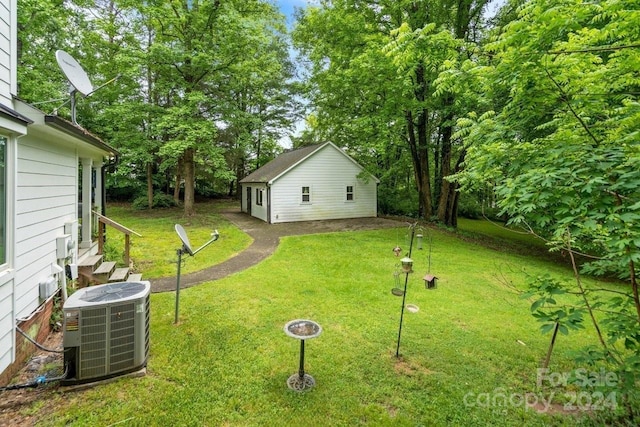 view of yard with an outbuilding and central AC