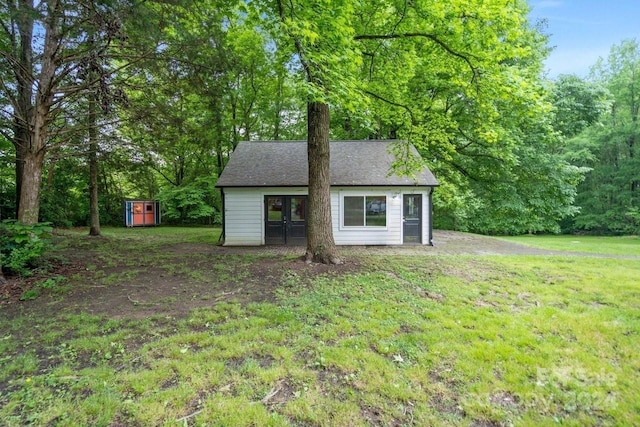 view of outdoor structure featuring a lawn