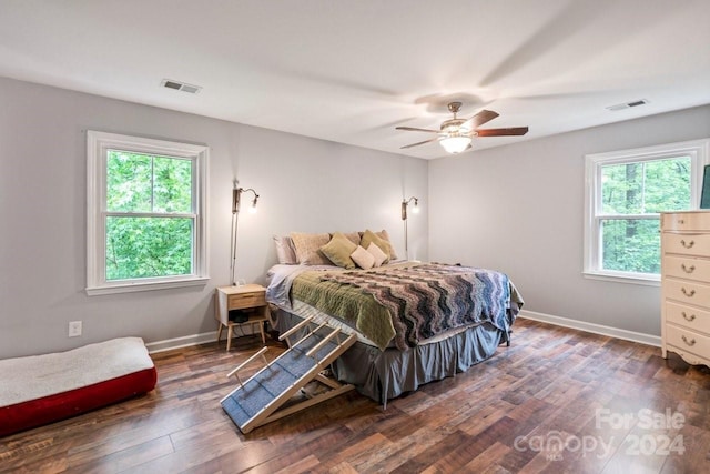 bedroom with ceiling fan and dark hardwood / wood-style floors