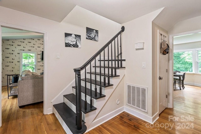 stairs featuring hardwood / wood-style floors