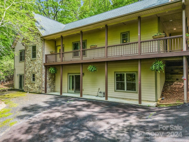 back of property featuring a balcony