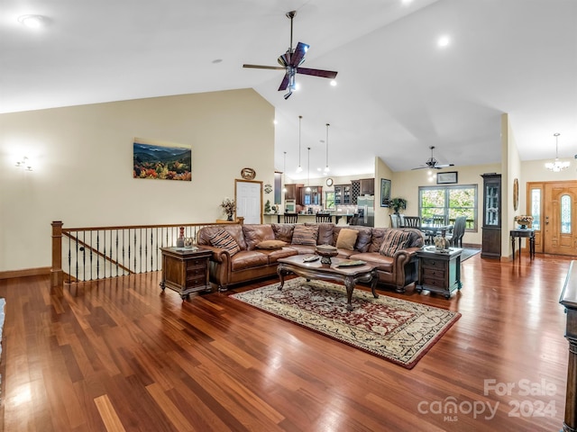 living room featuring ceiling fan with notable chandelier, high vaulted ceiling, and dark hardwood / wood-style flooring