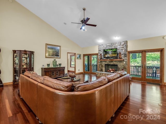 living room featuring ceiling fan, a fireplace, french doors, and dark wood-type flooring