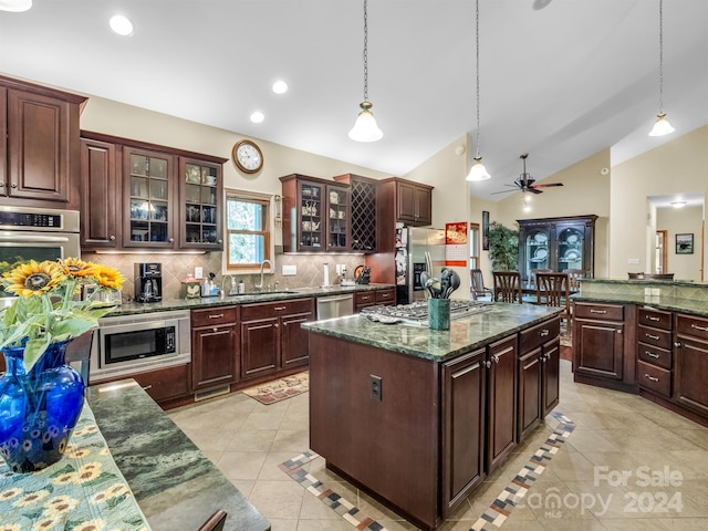 kitchen featuring a center island, pendant lighting, stainless steel appliances, and ceiling fan