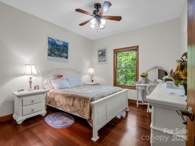 bedroom with dark hardwood / wood-style flooring and ceiling fan