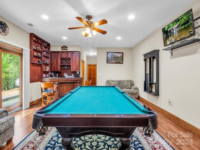 rec room with indoor bar, light wood-type flooring, ceiling fan, and billiards