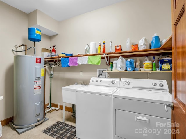 washroom featuring light tile flooring, washer hookup, washer and dryer, and electric water heater