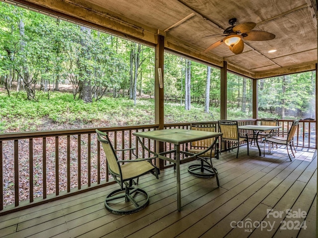 wooden terrace featuring ceiling fan