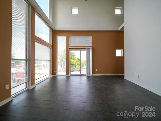 spare room featuring a towering ceiling