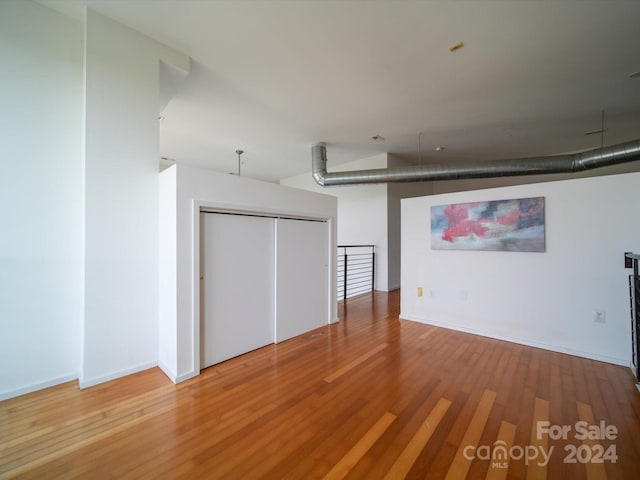 basement with hardwood / wood-style flooring